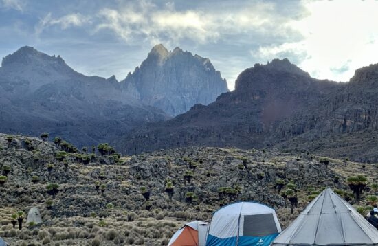 Panoramic view of Mount Kenya's majestic peaks including Batian, Nelion, and Point Lenana against a backdrop of clear blue sky