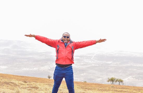 Scenic view of Ngong Hills against a backdrop of blue sky and lush greenery