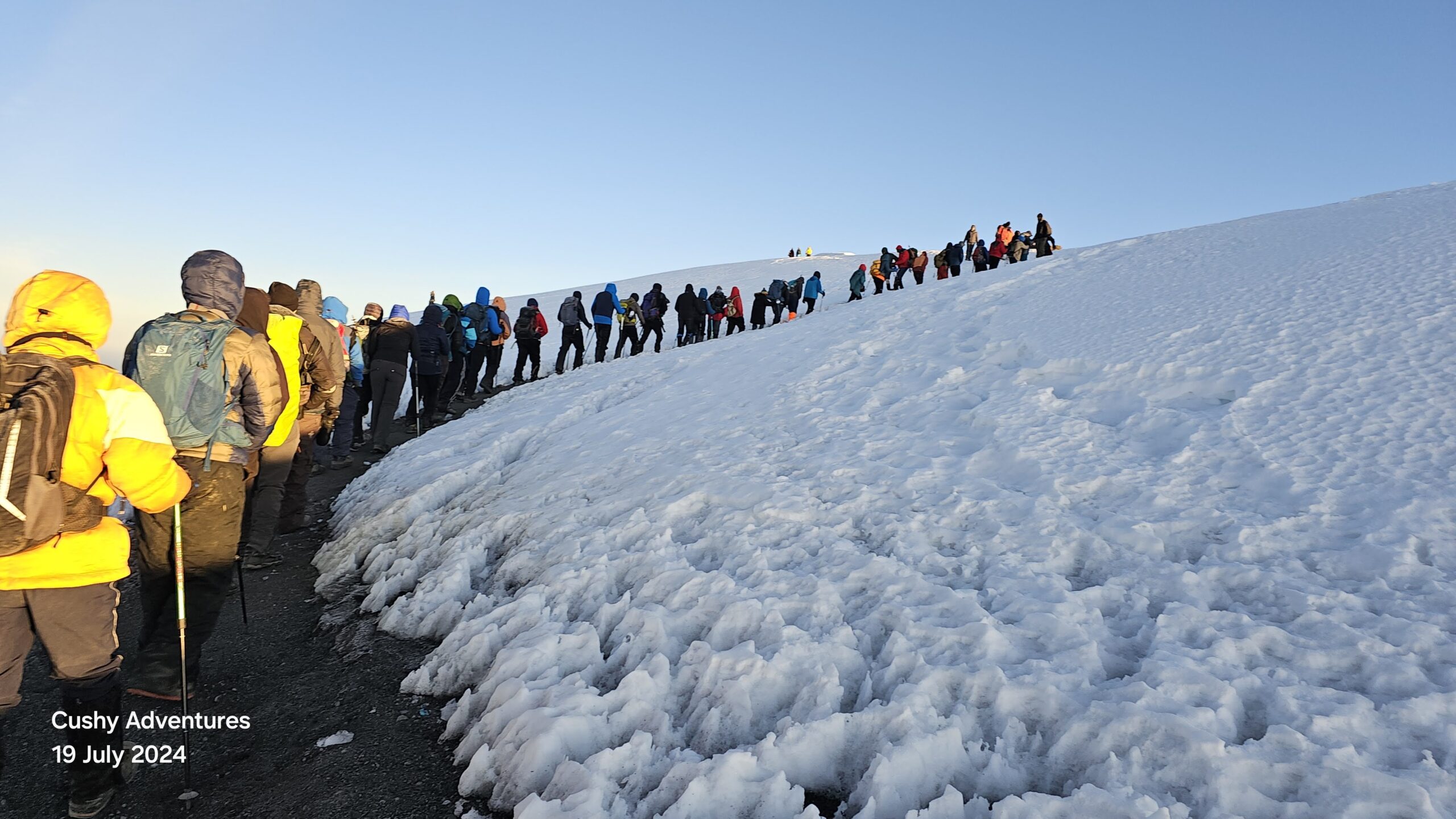 Hikers ascending past Stella Point toward Uhuru Peak on Mt. Kilimanjaro