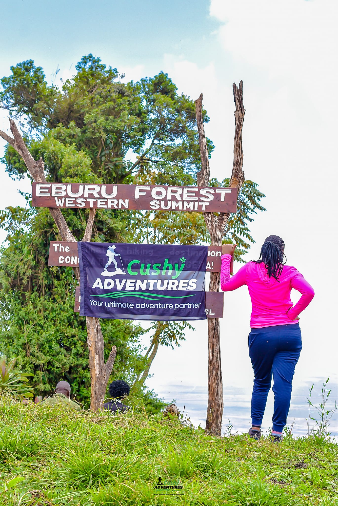 Cushy Community hiker at Eburru Western Summit sign.