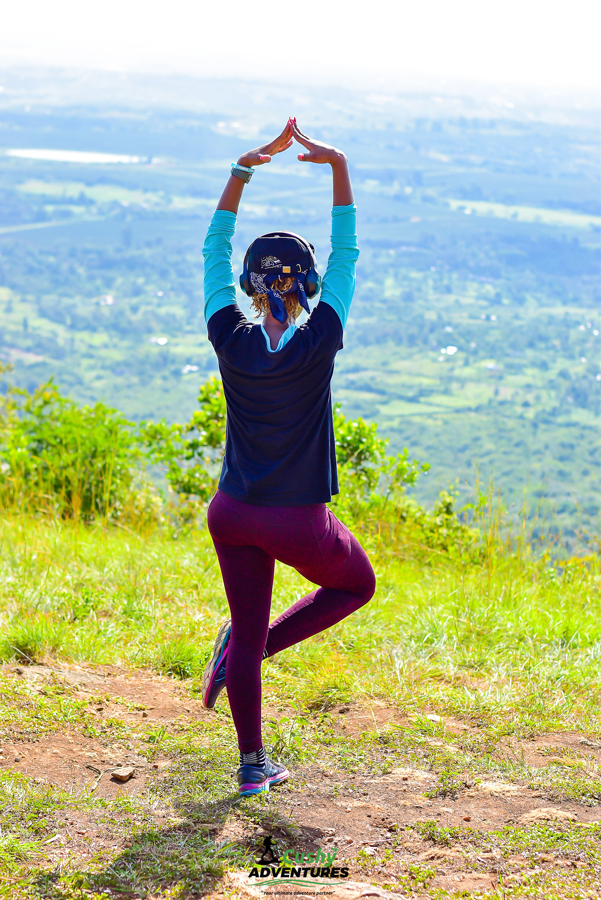 Lady Hiker at Mount Kilimambogo Summit β Cushy Adventures Lady hiker posing and enjoying panoramic views from Mount Kilimambogo summit