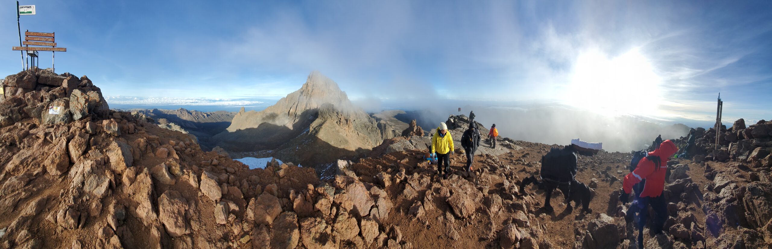 Cushy Adventures community hikers standing at Mount Kenya’s Point Lenana summit enjoying panoramic views